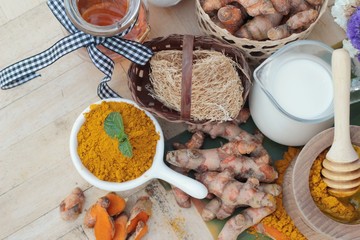 Turmeric powder with honey and milk for scrub.