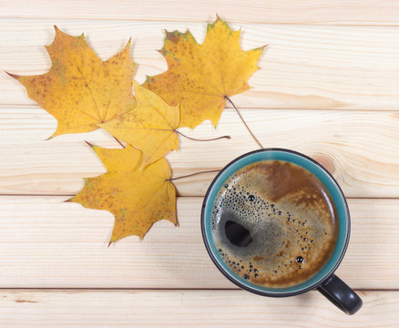 Cup of coffee on the autumn background.