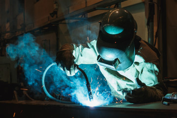Welder of Metal Welding with sparks and smoke