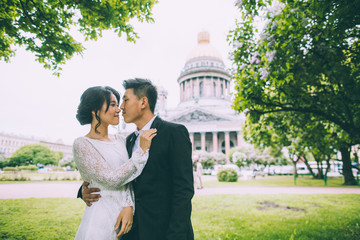 Naklejka premium Bride and groom on the background of St. Isaac's Cathedral