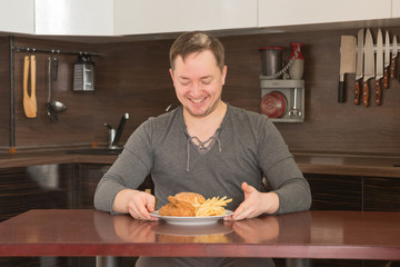 Young man eat junk food at home