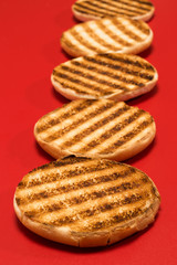 fried pieces of bread in a row on a red table