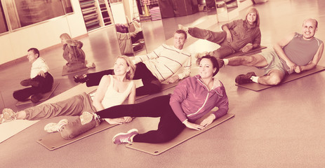 Adults doing pilates routine