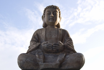 Fototapeta premium Sitting Buddha image on blue sky background.