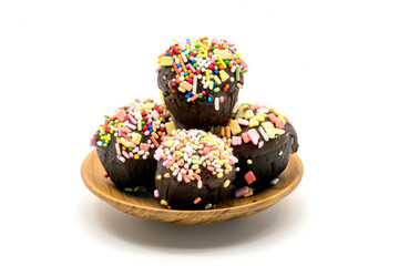 Assorted sweet chocolate cupcake in wooden plate