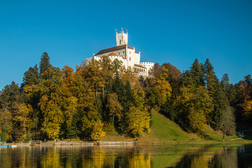 Fototapeta na wymiar Castle of Trakoscan on the hill in autumn, Zagorje, Croatia, reflection on the lake