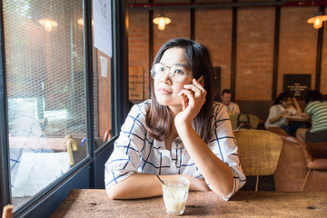 Woman sitting in loft cafe use Mobile Phone business Connection