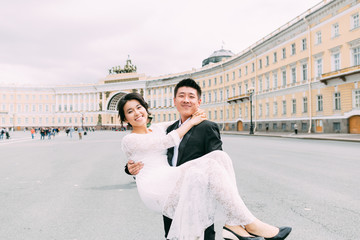 Groom holding bride in his arms