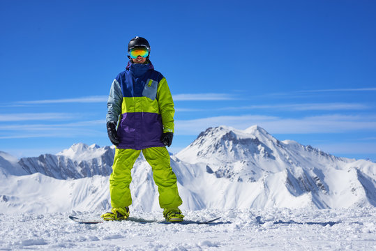 snowboarder standing on the top of a mountain