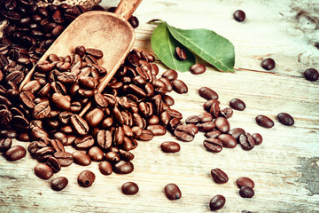 Roasted coffee beans with old wooden scoop. Coffee concept