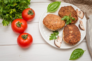 Homemade meat cutlets on white wooden table