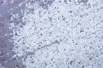 Partly whitewashed concrete wall with rich and various texture