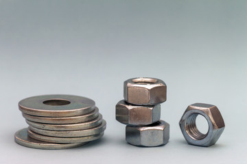 Joiner's accessories. Stacks of metal screw washers and nuts iso