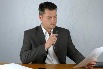 Young business man writing on a paper