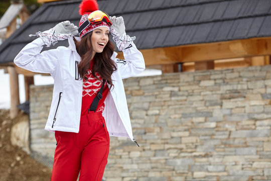winter, leisure, sport and people concept - happy young woman in