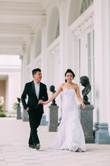 Fototapeta premium Groom and bride kiss near Wedding palace
