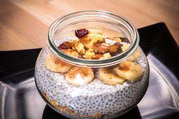 Chia seed pudding with nuts and slices of banana. Healthy dessert