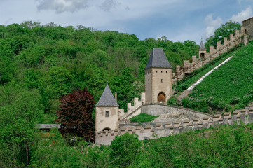 Fototapeta na wymiar Towers and walls of famous medieval Karlstejn castle near Prague in Czech Republic