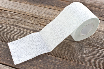 Toilet paper roll on wood background