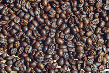 roasted coffee beans on the surface closeup top view, background