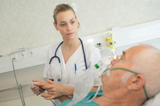 doctor measuring blood pressure in a hospital