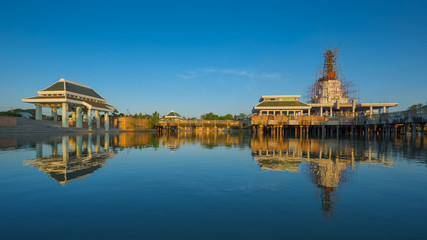 Fototapeta premium Buddha statue and reflection on water at Buddhamonthon, in Phra