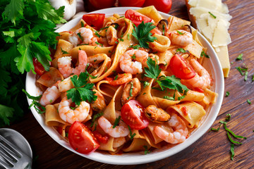 Tasty Pappardelle pasta with shrimp, Squid, mussel, tomatoes and herbs.