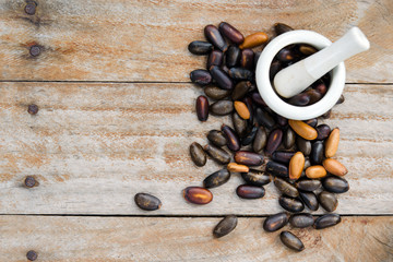 Heap of custard apple seeds or kernels isolated on wood with bla