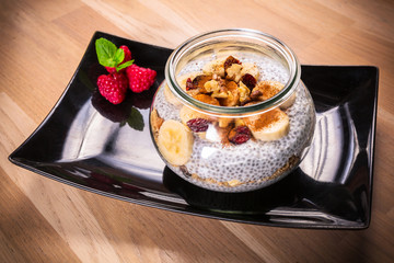 Chia seed pudding with nuts and slices of banana. Healthy dessert