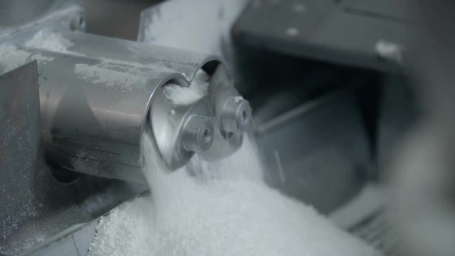 Two small mills rotating with white powder