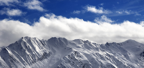 Panoramic view on snow winter mountains and sunlight cloud sky i