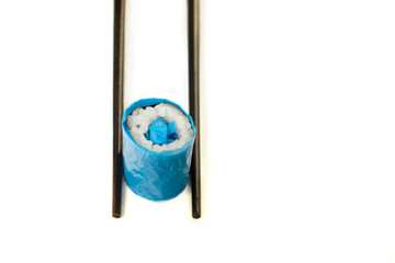 Plastic sushi-rolls  as an illustration unnatural and  polluted modern food. Environmental concept