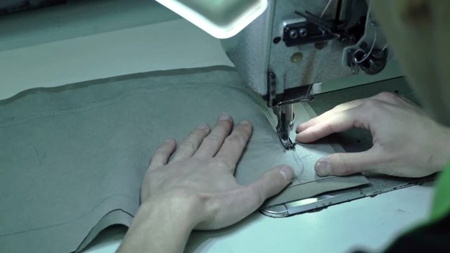 Taylor sews part of the sewing machine