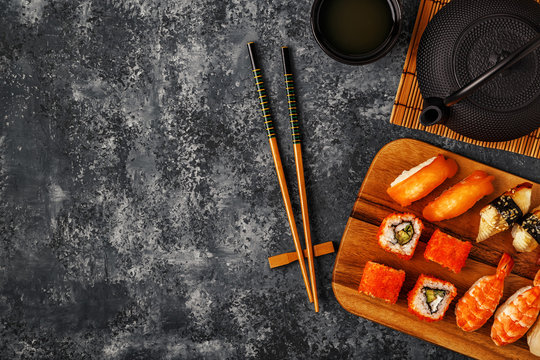 Sushi Set: sushi and sushi rolls on wooden plate.