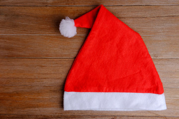 Obraz na płótnie Canvas Santa hat on wood background.
