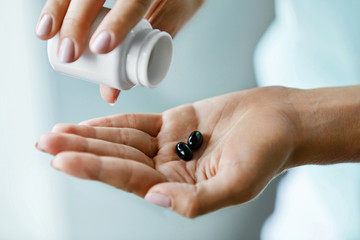 Medicine. Closeup Of Female Hand Pouring Pills Into Palm