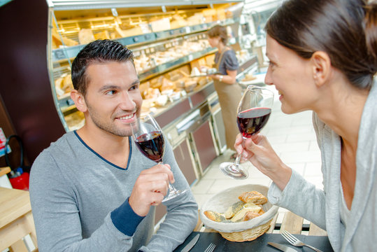 Couple drinking red wine with a meal
