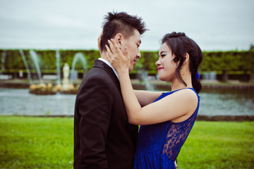 Obraz premium Bride and groom on their wedding day outdoors. Chinese bride in a blue dress