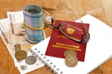 Pension certificate, wallet and money desk. Pension payments/ Ru