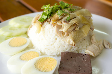 Hainanese chicken rice boil egg on white plate