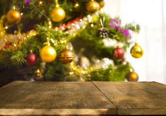 Fototapeta na wymiar christmas table background with christmas tree out of focus