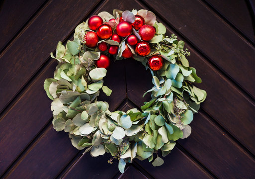 Before Christmas an advent wreath hanging on a wooden door