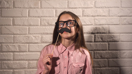 Girl holding a banner with moustache 