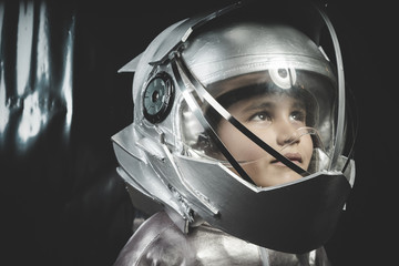 Boy playing to be an astronaut with space helmet and metal suit © Outsiderzone