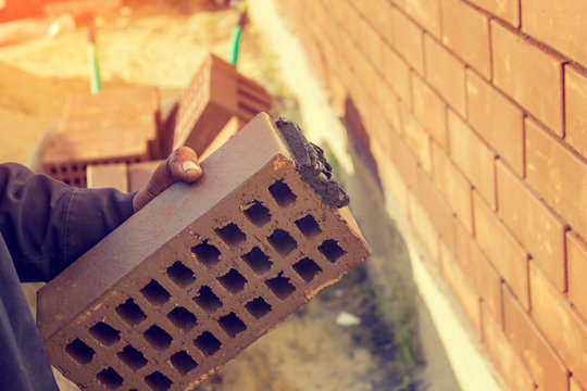 Bricklaying, construction work, manual labor.