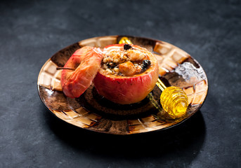 Baked apple stuffed and spoon for honey