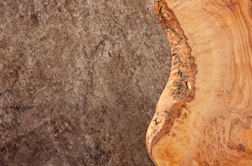 Empty wood olive cutting board on a marble background