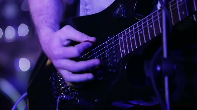 Rock musician playing six string electric guitar