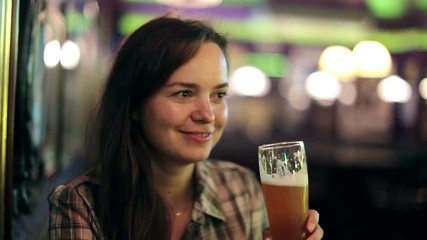 Beautiful sexy girl drinking beer at bar
