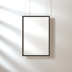 White poster with black frame mockup hanging on the wall with shadows, 3d rendering